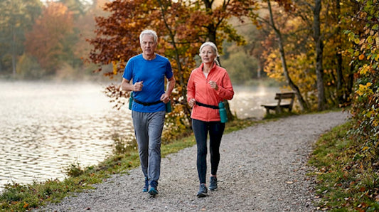 Older couple walking briskly in park