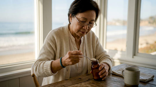 Senior woman measuring calcium supplement at table