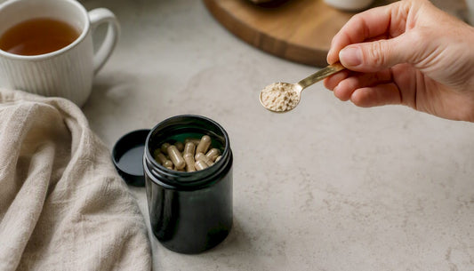 Hand measuring quercetin powder near capsules